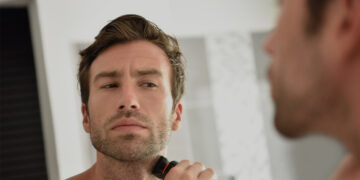 This is the cover photo for our Best Electric Shaver article. It features a man shaving with an electric shaver.