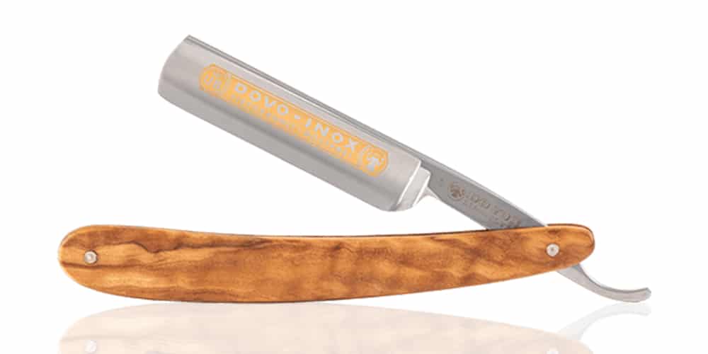This is a product image in our Best Straight Razor Laptop in 2024 article. It is a photo of a Dovo Inox Straight Razor overlaid on a minimalistic white background with a Burbro logo.