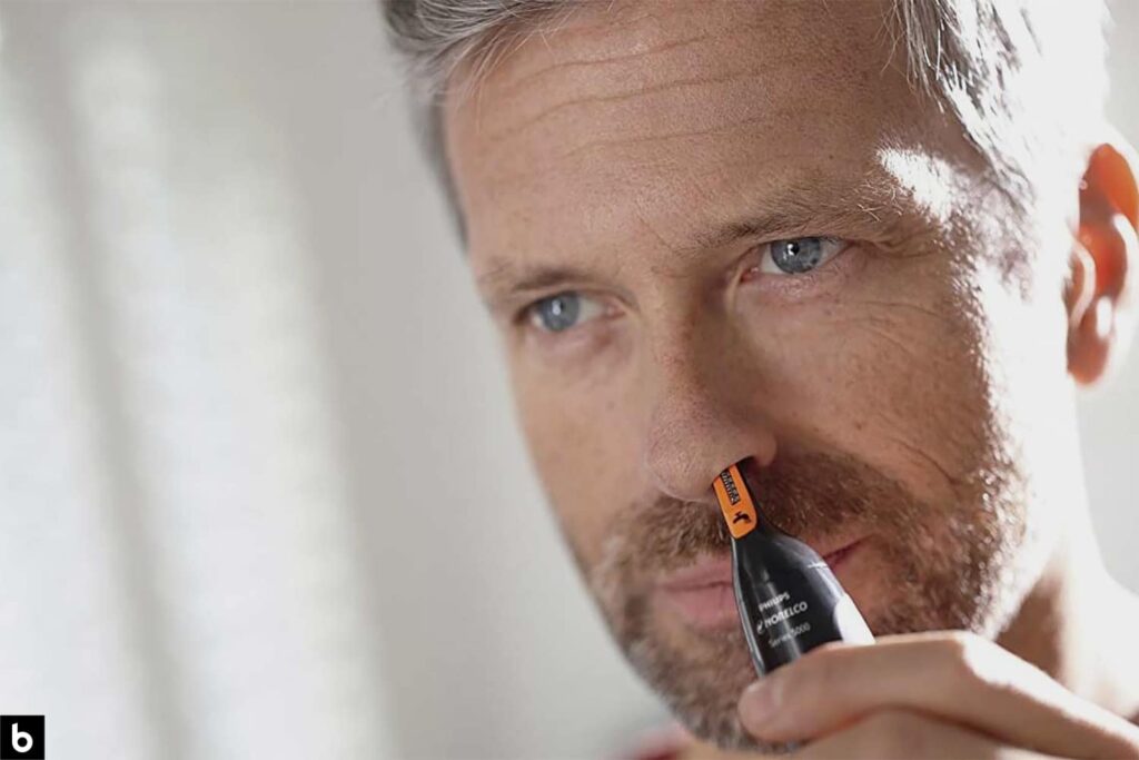 This is the feature image for our Nose Hair Trimmer 2024 Buying Guide. It features a middle-aged man shaving his nose hair.