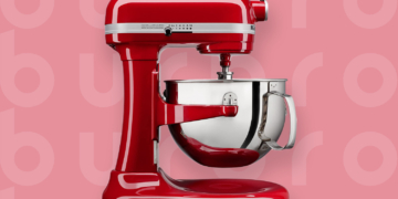 This is the cover photo for our Best Stand Mixer article. It features a red Cuisinart stand mixer overlaying a light red background with an embossed Burbro logo.