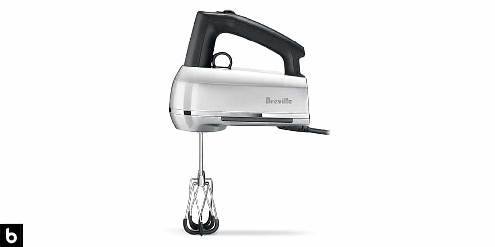 This is a product image in our Best Hand Mixers in 2024 article. It is a photo of a metallic silver Breville Handy Scraper Mixer with rubber attachments overlaid on a minimalistic white background with a Burbro logo.