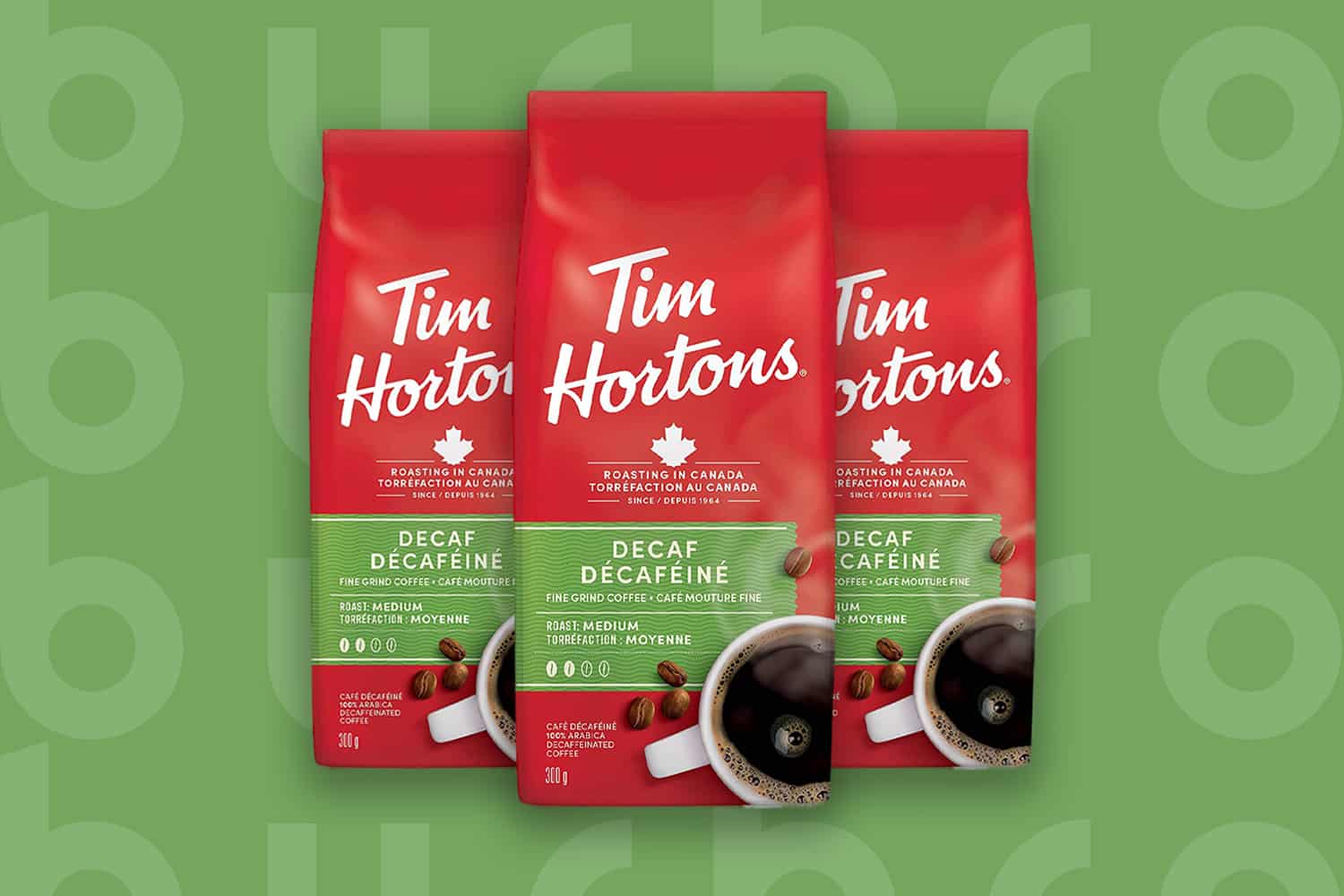 This is the cover photo for our Best Decaf Coffee article. It features 3 red bags of Tim Hortons coffee overlaid on a fresh green background with an embossed Burbro logo.