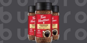 This is the cover photo for our Best Instant Coffee article. It features 3 cans of Tim Hortons instant coffee overlaid on a dark background with an embossed Burbro logo.