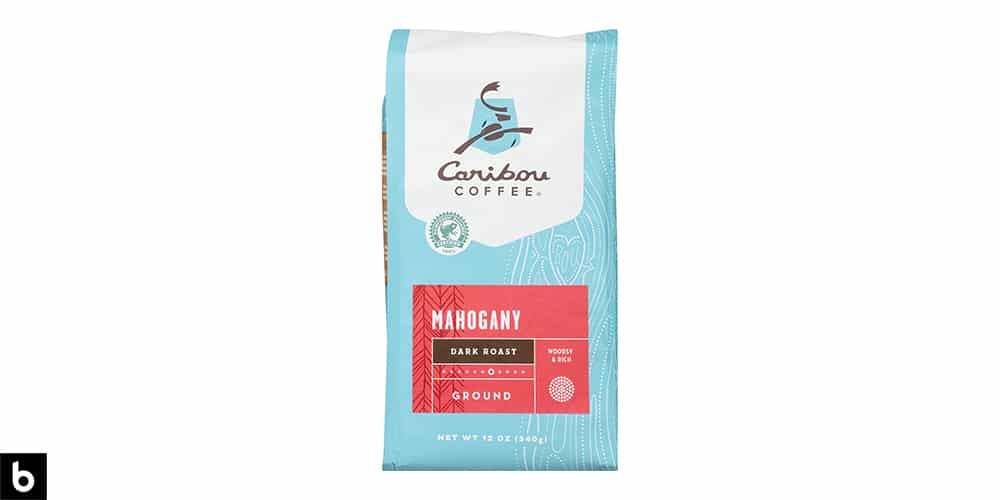 This is a product image of a blue and red bag of Caribou Coffee Mahogany dark roast coffee.