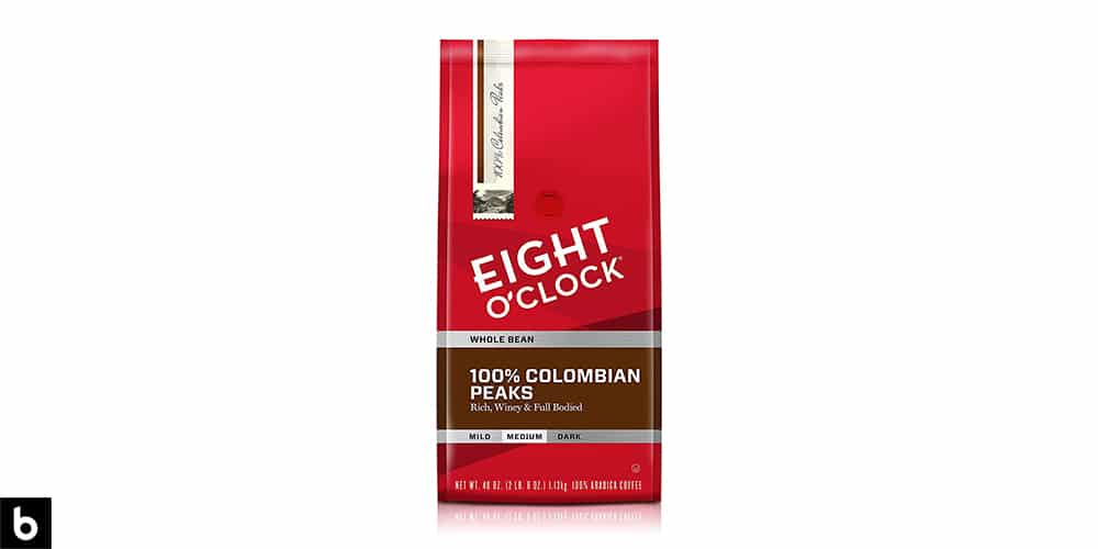 This is a product image, featuring a red and brown bag of Eight O-Clock whole bean 100% Colombian Peaks coffee.