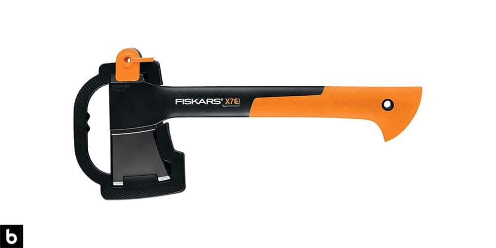 This is a product image for our Best Hatchets 2023 article. It features a black and orange Fiskars hatchet.