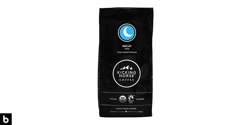 This is a product photo, featuring a black and blue bag of Kicking Horse Dark Roast Decaf Coffee.