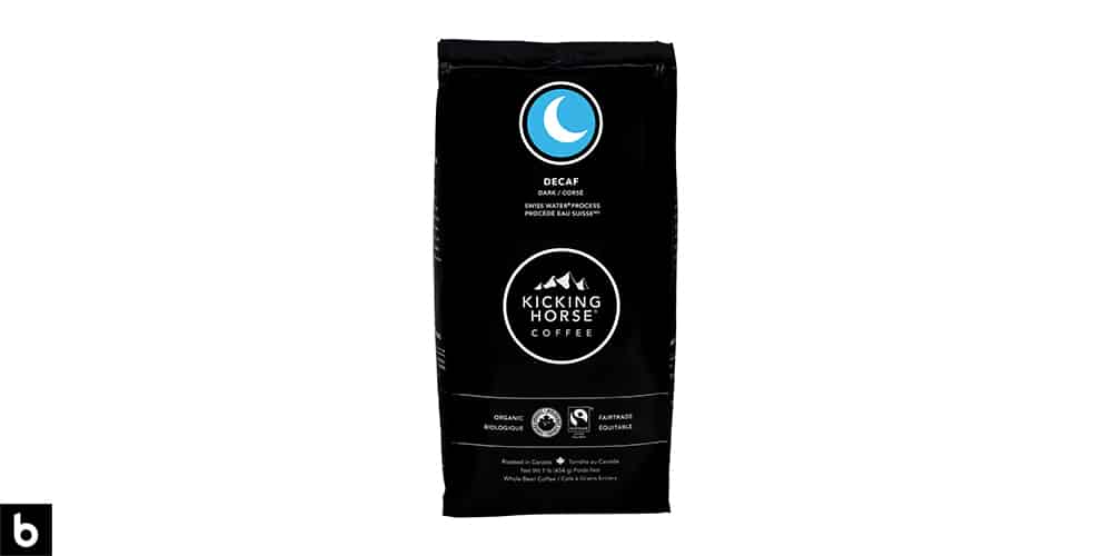This is a product photo, featuring a black and blue bag of Kicking Horse decaf coffee.
