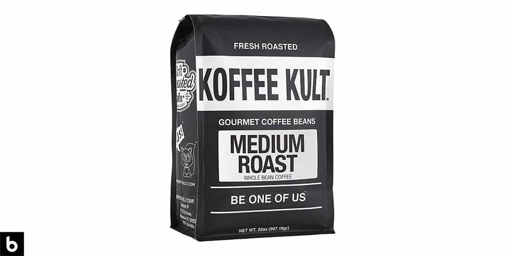 This is a product photo, featuring a black and white bag of Koffee Kult medium roast coffee beans. We've chosen it as One of the Best Gourmet Coffees for Cold Brews.