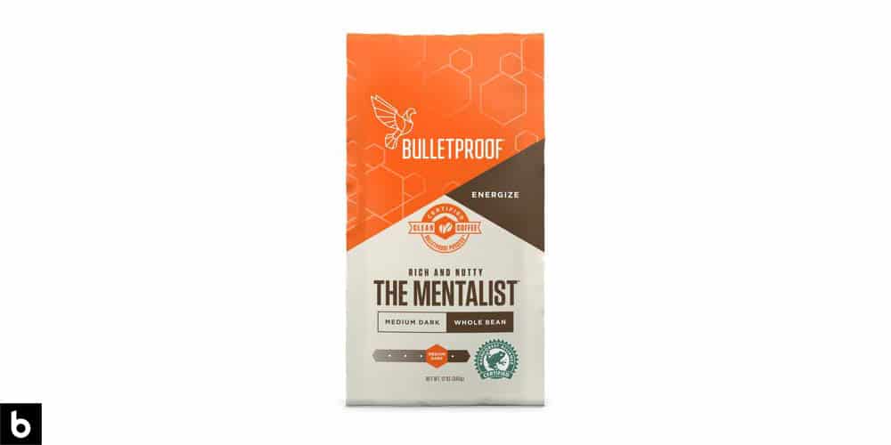 This is a product image, featuring a orange, brown, and cream bag of Bulletproof 'The Mentalist' Whole Bean Coffee. We've dubbed it one of the best Budget-Friendly Coffees for French Press.